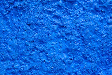 Rough blue cement wall surface. This image is suitable for use as wallpaper or background. Sandy surface.