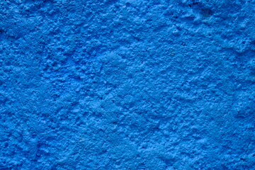 Rough blue cement wall surface. This image is suitable for use as wallpaper or background. Sandy surface.