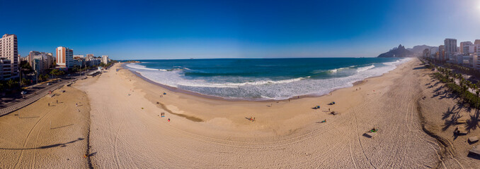 Panorama 180 degrees of Ipanema and Leblon beach with few people enjoying late afternoon where...