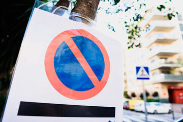 Parking prohibited sign on a busy street.