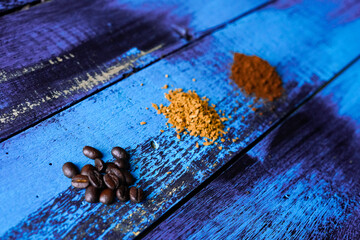 coffee beans ground beans on top of purple wooden table top view