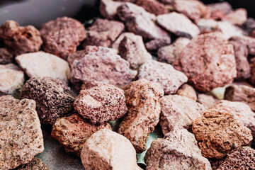 Volcanic lava rocks on a barbecue to transmit the heat of the flame.