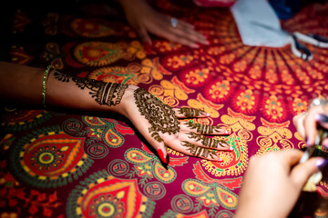 Mehndi henna herbal tattoo drawing on bride hand traditional art and bridal design during Indian...