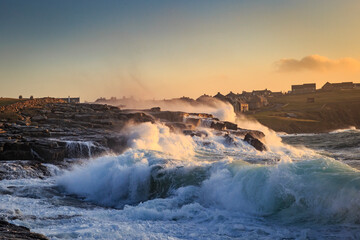 Waves crashing at sunrise