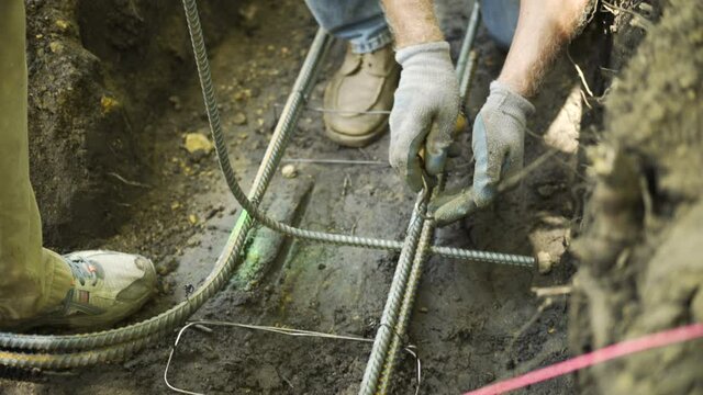 Construction Worker Using Wire Twister on Concrete Rebar, Close Up