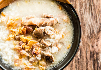 Pork bone boiled rice  in bowl, out door Chiangmai Thailand