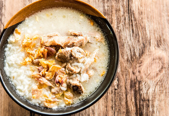 Pork bone boiled rice  in bowl, out door Chiangmai Thailand