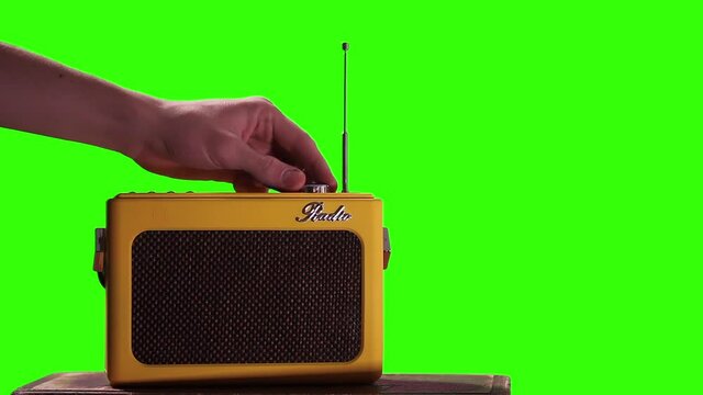 Young Male Hand tuning Old Radio on Green Screen. You can replace green screen with the footage or picture you want. You can do it with &ldquo;Keying&rdquo; effect in After Effects.
