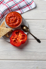 Delicious vegetable ajvar made from baked red pepper. Home cooked. Balkan cuisine. Space for text. Vertical orientation.