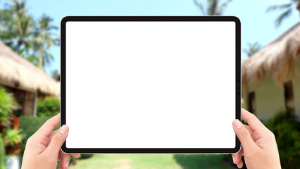 Human two hands holding tablet computer white screen mockup in resort