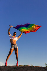 Confident Man celebrating equality and pride during sunset.
