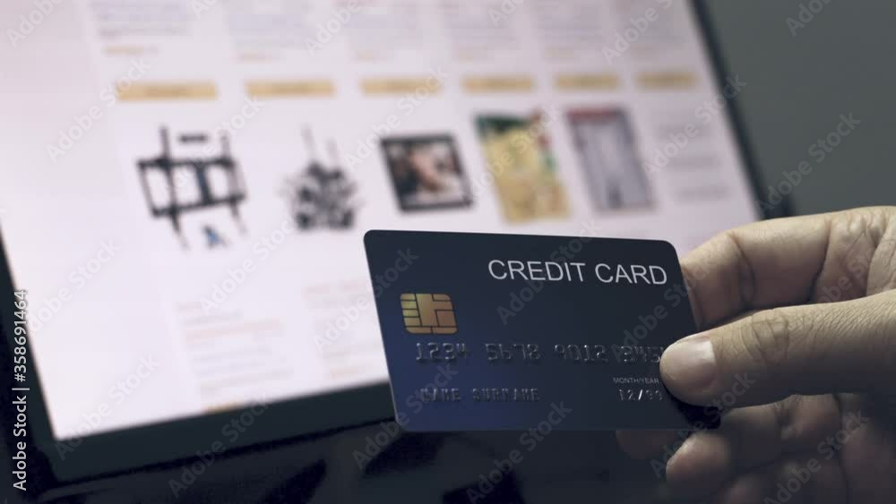 Poster 4k video hand hold credit card in front of ecommerce website in monitor. video concept for online sh