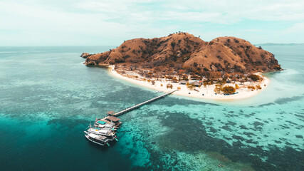 Aerial view of Kanawa Island in Komodo National Park, Labuan Bajo, Indonesia. Beautiful island with resort and wooden pier