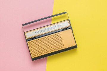 Retro radio on a yellow and red background. Vintage technique.