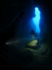 Fototapeta na wymiar cave diving underwater scuba divers exploring cave dive ocean scenery