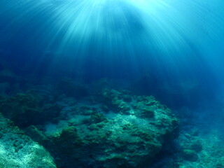 Fototapeta na wymiar sun ray and sun beam scenery underwater waves on surface of water slow ocean scenery backgrounds