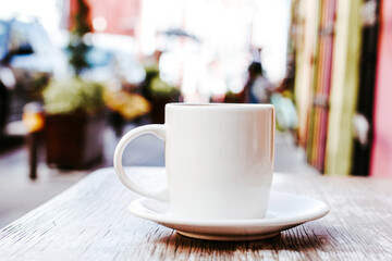 cup of coffee in the street or outdoors at coffee shop or cafe with blurred background
