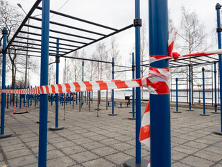 Playground with fitness equipment in Petrozavodsk (northwest of Russia) fenced with tape during quarantine for coronavirus infection COVID-19