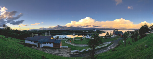 Super wide panorama of Puerto Williams, the sea and nature in a beautiful day with blue sky and...