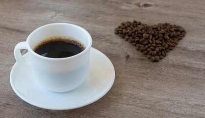 making coffee. Cup of fragrant coffee. beans are laid out in the shape of a heart.