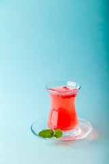 Fresh fruit red tea in transparent turkish teacup