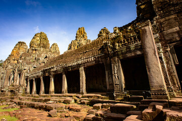 Fototapeta premium It's Bayon, Khmer temple at Angkor in Cambodia. Official state temple of the Mahayana Buddhist King Jayavarman VII