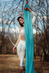 girl in white on a Hoop in the woods