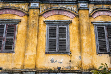 Retro window on the yellow wall in Hoi An, Vietnam