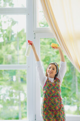 Cleaning concept. Young woman washing window, close up