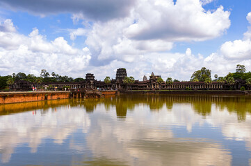 Fototapeta premium It's Angkor Wat (Temple City) and its reflection, a Hindu, then a Buddhist, temple complex in Cambodia and the largest religious monument in the world.