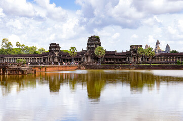 Fototapeta na wymiar It's Angkor Wat (Temple City) and its reflection, a Hindu, then a Buddhist, temple complex in Cambodia and the largest religious monument in the world.