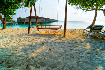 Exotic Tropical Paradise Swings over Crystal Clear Turquoise Blue Ocean Sea Water Landscape Seascape