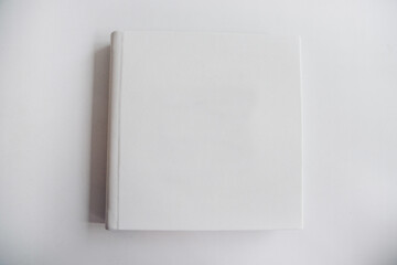 white book wrapped in leather on a white background. photo album from with a pure cover copy space. Greeting card