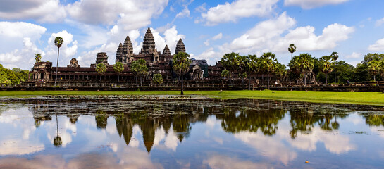 It's Angkor Wat (Temple City) and its reflection in the lake, a Buddhist, temple complex in Cambodia and the largest religious monument in the world. View from the garden