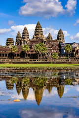 Fototapeta premium It's Angkor Wat (Temple City) and its reflection in the lake, a Buddhist, temple complex in Cambodia and the largest religious monument in the world. View from the garden