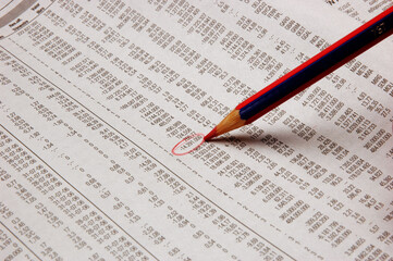 Pencil pointing over sheets accounts