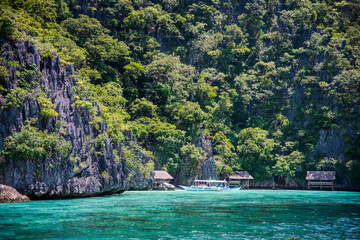 Private cottages in white sand beach  with majestic limestone wall in the back