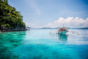 Fototapeta premium Tourist enjoying the clear turquise waters of Coron, Palawan, Philippines