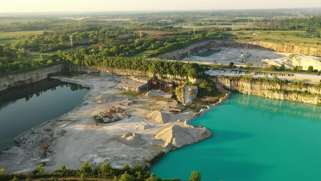 Aerial view of Stone Plant. Quarrying and manufacturing of natural stone products for building, construction, landscaping purposes. Industrial landscape, turquoise water, summertime, early morning, 