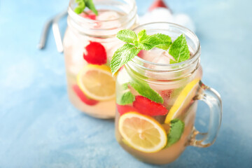 Mason jars of fresh strawberry lemonade on table