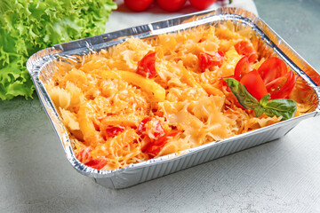 Tasty baked pasta in dish on light background