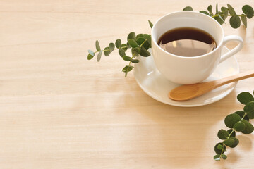 A cup of coffee on a wood table