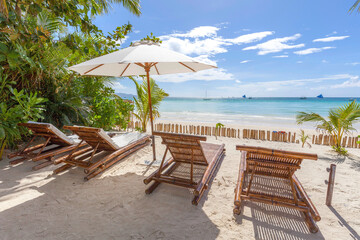 beach chairs and umbrella on the beach, white beach path, Boracay island, Philippines.