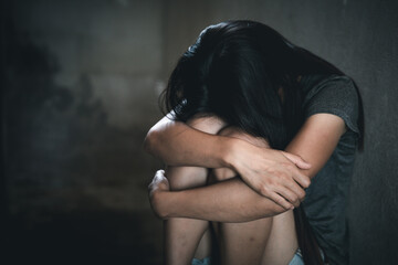 Young depressed woman, domestic and rape violence,beaten and raped sitting in the corner,  Copy...