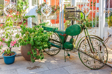 Fototapeta na wymiar Ornate bicycle and potted plant on the streets of Gulangyu Island in China