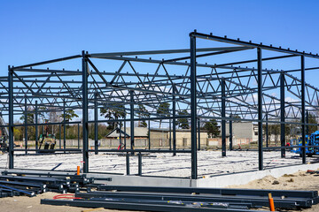 Naklejka premium Structure of steel for building construction on blue sky background.