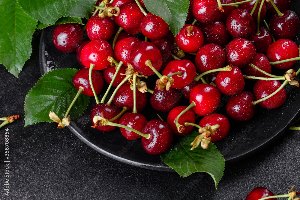 Wall mural fresh delicious red bright cherry berries torn in the summer garden