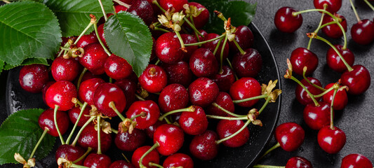 Fresh delicious red bright cherry berries torn in the summer garden