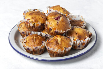 Homemade muffins with red berries and cherries