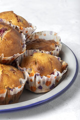 Homemade muffins with red berries and cherries